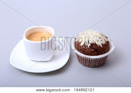 Classic espresso in white cup with homemade cake and chocolate on white background