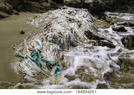 Abandoned fishing net left to decay on a beautiful sandy beach