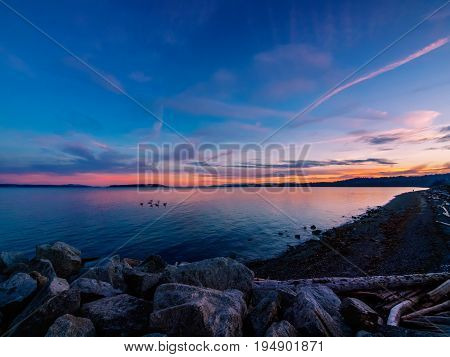 Sunset on the rocky beach in Sidney Vancouver Island British Columbia Canada