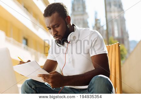 So much to do. Scrupulous talented industrious guy taking notes while feeling inspired and thinking about his startup