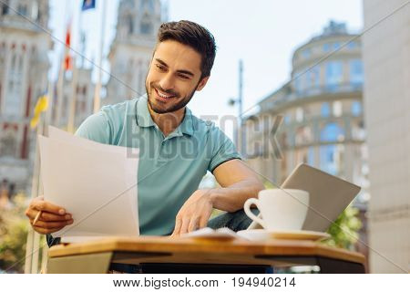 Scrupulous worker. Passionate intelligent quick witted guy working as a freelancer and enjoying his day outside the house while spending at public workspace outdoors