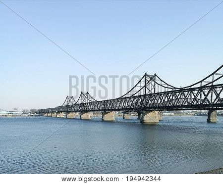 China - North Korea Friendship bridge; across the Yalu river. Taken in April, 2017, from public area in Dandong, Liaoning China, opposite to Sinuiju city, DPRK.
