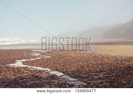 Legzira dramatic natural stone arches reaching over the sea, Atlantic Ocean, Morocco, Africa