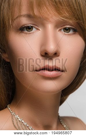 portrait of young beautiful woman in a necklace