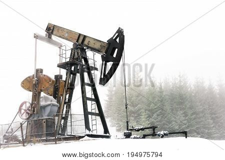 Working oil pump jack at carpathian mountains, Ukraine