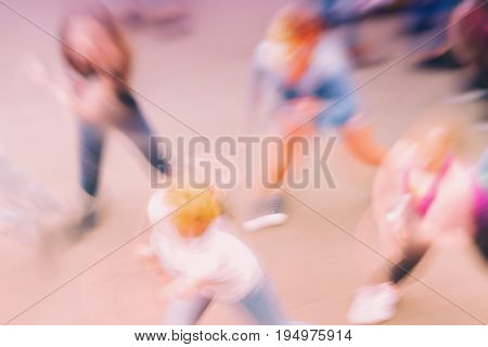 Abstract blurred background with group of unidentified people dancing on outdoor area. Top view. Concept of active healthy lifestyle, sport, leisure. For background , backdrop, substrate, colour trend