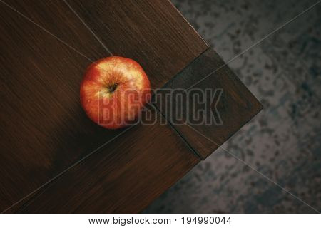 A red ripe tasty apple from above on a dining table - Vintage Look