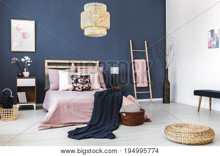 Round wicker footrest placed on the floor in stylish hotel room