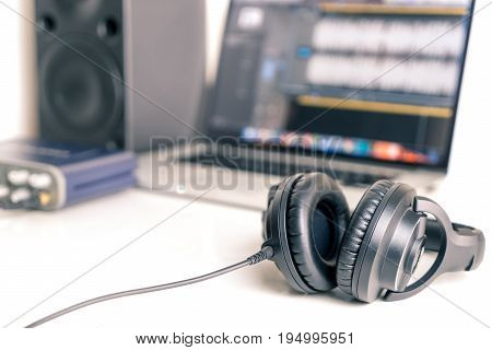 Black studio headphone in DAW music studio laptop