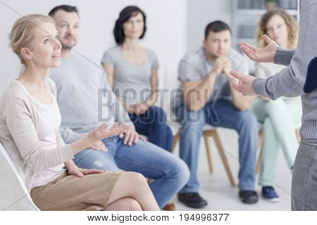 Woman psychologist speaking during group psychotherapy session