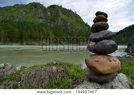 Stone pyramid near Katun river in Altay mountains. Chemal Altay Republic Siberia Russia.
