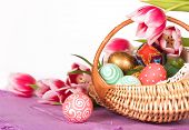 Basket full of Easter eggs  and tilips