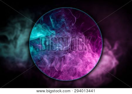 Close-up сloud Of Pink And Blue Smoke  Blown Under A Magnifying Glass On A Black Isolated Background