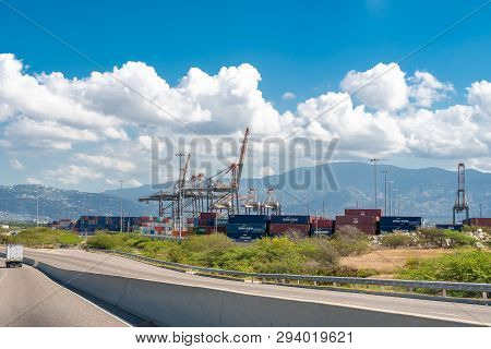 Saint Catherine, Jamaica - March 19 2019: Cargo Shipping Containers And Container Cranes At The Port