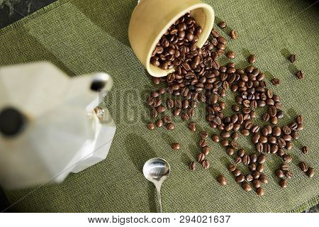 Pot, Bowl And Coffee Beans Slathered Over Table, View From Above