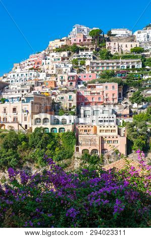 Vertical View Of The Colorful Houses Of Positano Framed With Flowers