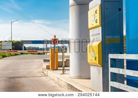 Automatic Card Dispenser Point Of Entry Toll Booth For Toll Road. Red X Signal Barrier Down Until Ca