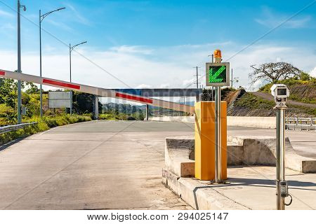 Point Of Entry For Toll Road. Green Signal Barrier Opens To Enter.