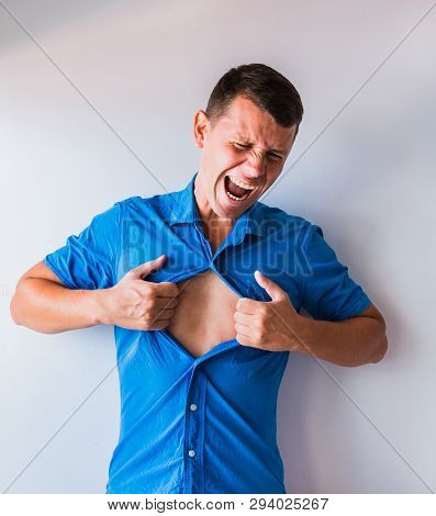 Businessman Tearing Off His Shirt And Showing Mucular Body Concept On Background