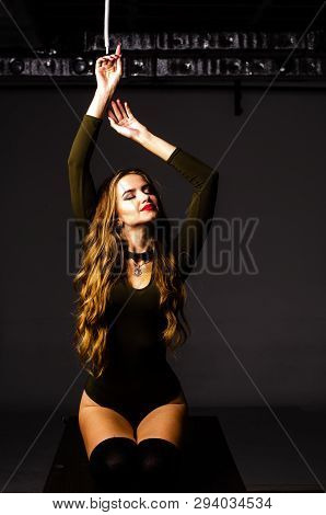 Beautiful Dancer. Girl Model. The Girl Sits In A Hat And Sits On A Table. Girl In A Beautiful Underw