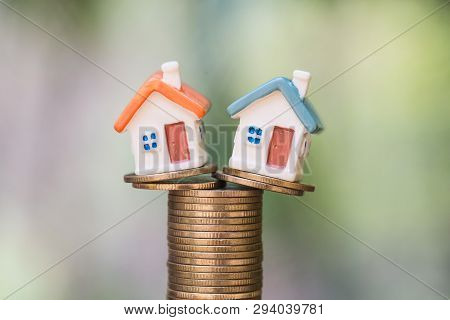 Mini House On Stack Of Coins,money And House,  Mortgage, Savings Money For Buy House And Loan To Bus
