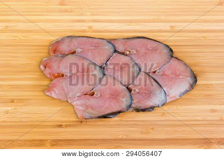 Top View Of The Slices Of Smoked Pink Salmon On The Wooden Bamboo Cutting Board
