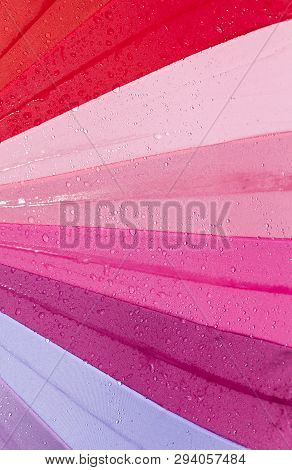 Multicolored Umbrella Covered With Drops Of Water From Rain Past Or Walking, Closeup Useful Items, T