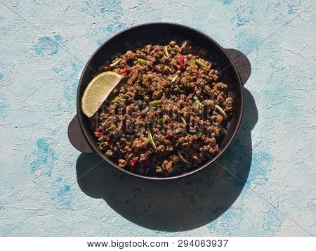 Indian Minced Meat Qeema In A Pan On A Sunny Blue Table.