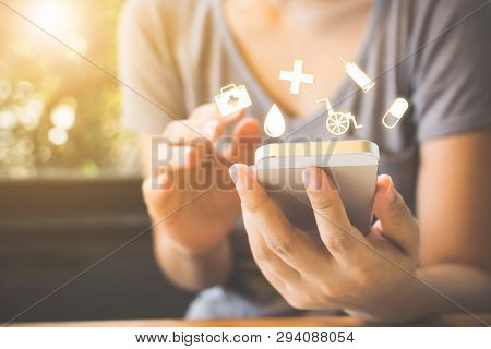 Hand Of Woman Using Mobile Phone.she Is Deciding To Make Health Insurance