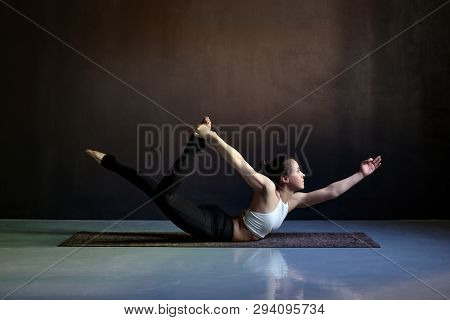 Young Attractive Woman Practicing Yoga, Stretching In Salabhasana Pose