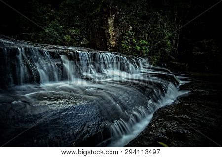 Belmore Falls Cascades Over Rocks Before A Second Cliff Drop Into The Next Section Of The Gorge