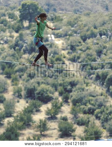 Woman Balancing On The Rope Concept Of Risk Taking And Challenge.
