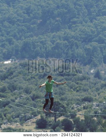 Woman Balancing On The Rope Concept Of Risk Taking And Challenge.