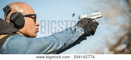 Catch A Bullet. Close-up Of Gun And Flying Motion Bullet