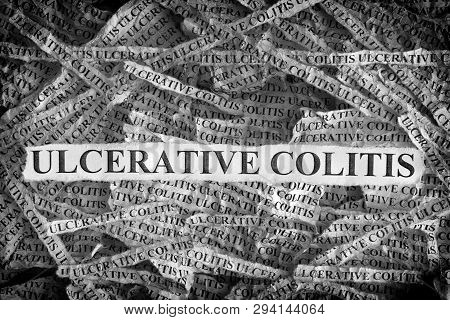 Ulcerative Colitis. Torn Pieces Of Paper With The Words Ulcerative Colitis. Concept Image. Black And