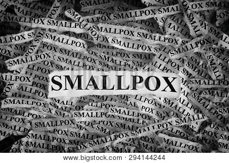 Smallpox. Torn Pieces Of Paper With The Words Smallpox. Concept Image. Black And White. Close Up.