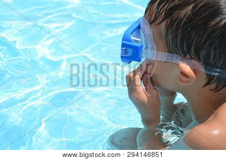 Teenager Boy Wearing Mask Swimming In The Pool. Happy Holiday Concept. Cute Happy Little Boy Swimmin