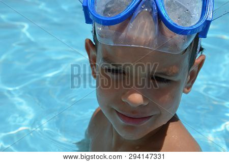 Teenager Boy Wearing Mask Swimming In The Pool. Happy Holiday Concept. Cute Happy Little Boy Swimmin