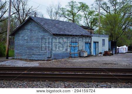 Abandoned Brick Train Depot With Tracks And Graffiti