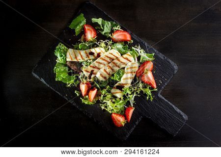 Salad With Grilled Halumi With Strawberries And Arugula.