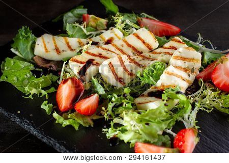 Salad With Grilled Halumi With Strawberries And Arugula.