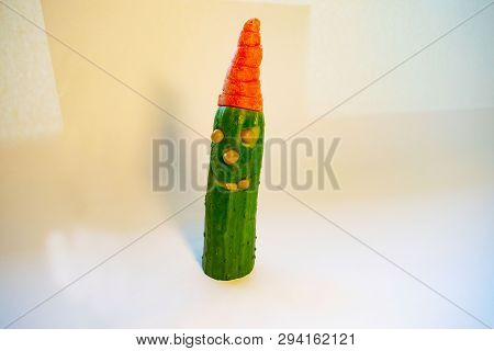 Funny Cucumber With Peas Instead Of A Tooth And A Carrot Hat