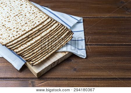 Stack Of Matzah Or Matza , Jewish Traditional Passover Celebration On A Wooden  Table With Copy Spac