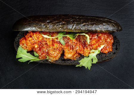 Black Hot Dog Bun With Minced Meat.