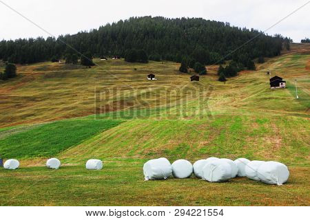 A packed haystacks on charming mountain meadows. Switzerland, the Alpes
