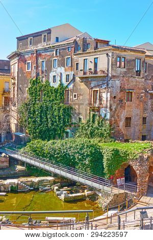 Old buildings on the ancient ruins of roman theater in Catania, Sicily, Italy