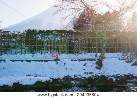 Mount Fuji At Oshino Hakkai In Snow Fall With River Mineral Water, Traditional Japanese Style House 