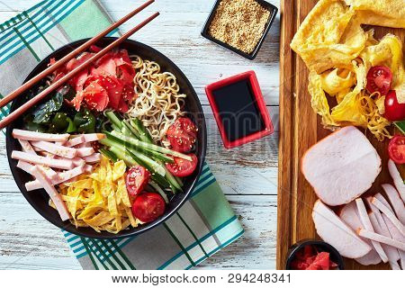 Overhead View Of Hiyashi Chuka, Cold Ramen Summer Salad - Chilled Egg Noodles  Topped With Cucumber,