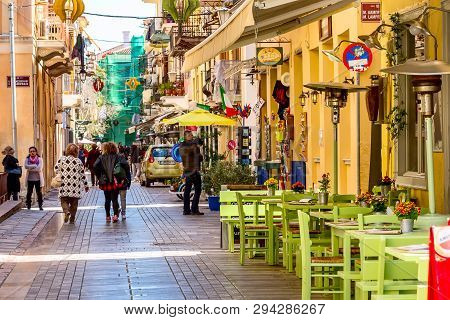 Nafplio, Greece - March 30, 2019: Old Town Street Panorama With Restaurants In Nafplion, Peloponnese
