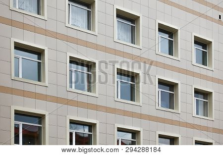 The Facade Of A Multi-storey Clinical Building. The Walls With Many Windows Are Finished With Plasti